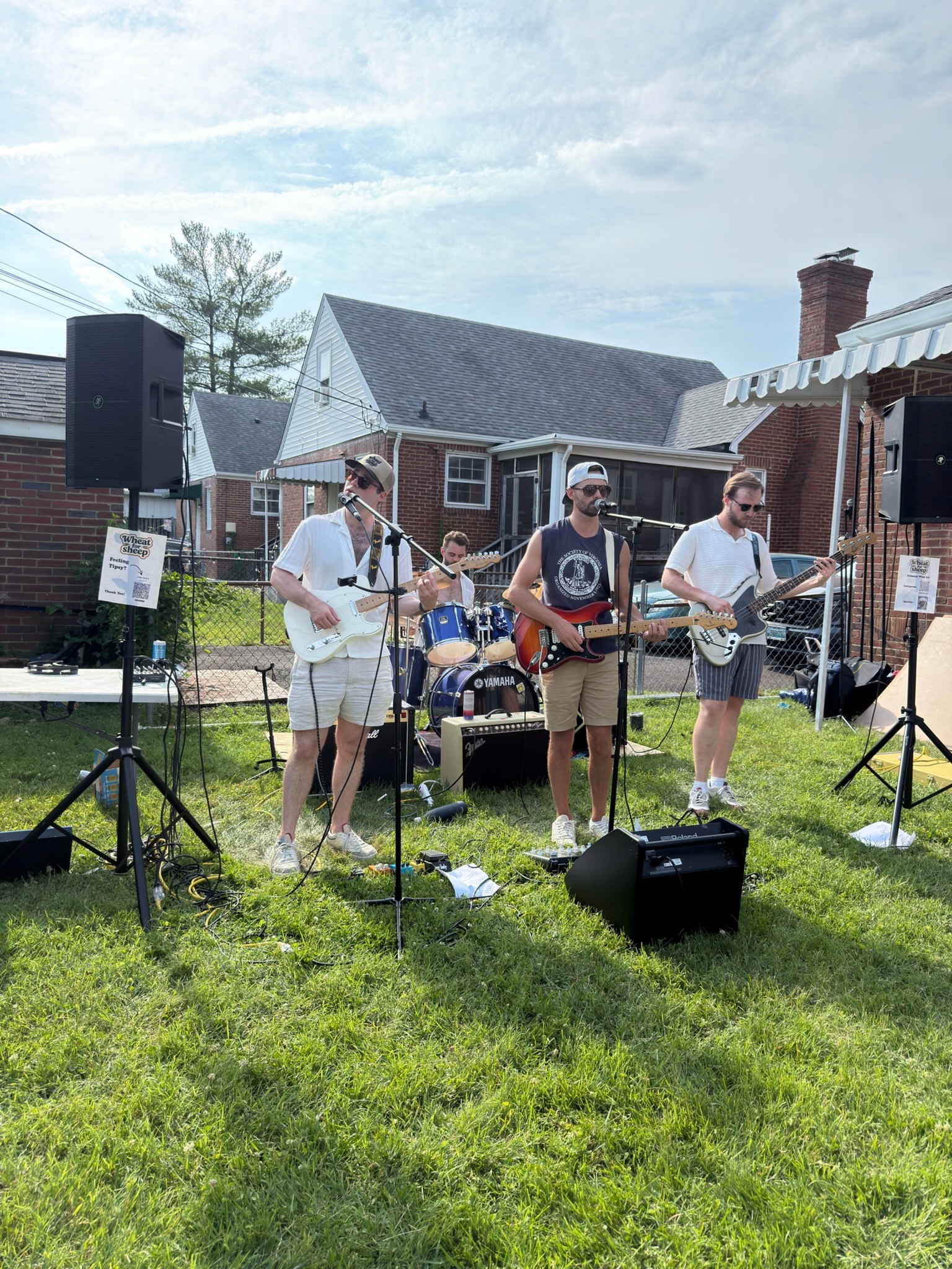 All four members of Wheat for Sheep playing a backyard set at the Shack